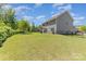 Expansive backyard with a lush lawn, mature trees, and space for outdoor activities at 1552 Trentwood Dr, Fort Mill, SC 29715