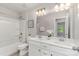 Bright bathroom boasts double sinks, tub with shower, and a large mirror at 1552 Trentwood Dr, Fort Mill, SC 29715
