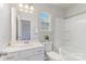 A pristine bathroom featuring a tub shower, window, and bright white vanity at 1552 Trentwood Dr, Fort Mill, SC 29715