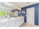 Main bathroom featuring double sinks, a large mirror, and stylish blue accent walls at 1552 Trentwood Dr, Fort Mill, SC 29715