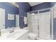 Stylish bathroom showcasing a glass enclosed shower, vanity, and dark blue accent wall at 1552 Trentwood Dr, Fort Mill, SC 29715