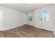 Sunlit bedroom boasts durable plank flooring and picturesque views through bright windows at 1552 Trentwood Dr, Fort Mill, SC 29715
