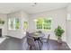 Bright dining area with a round table, four chairs, a pendant light, and large windows for natural light at 1552 Trentwood Dr, Fort Mill, SC 29715