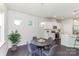 Charming dining area with a round table, stylish chairs, and a view into the kitchen, flooded with natural light at 1552 Trentwood Dr, Fort Mill, SC 29715
