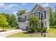 Well-manicured front yard of home, with lovely shrubbery, mature trees, and convenient two-car garage at 1552 Trentwood Dr, Fort Mill, SC 29715