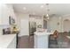 Bright kitchen features white cabinets, stainless steel appliances, and a breakfast bar at 1552 Trentwood Dr, Fort Mill, SC 29715