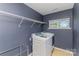 Functional laundry room with modern appliances, shelving, and natural light from the window at 1552 Trentwood Dr, Fort Mill, SC 29715