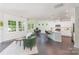 Open-concept living space featuring dark floors, an adjacent kitchen, and plenty of natural light from large windows at 1552 Trentwood Dr, Fort Mill, SC 29715