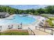 An aerial view of a beautiful pool area with multiple pools, a clubhouse, and tennis courts at 1552 Trentwood Dr, Fort Mill, SC 29715