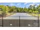 Outdoor tennis court surrounded by lush greenery, offering a great recreational amenity at 1552 Trentwood Dr, Fort Mill, SC 29715