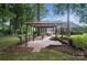 Charming back patio with brick paving and a pergola, perfect for entertaining at 15546 Thompson Rd, Mint Hill, NC 28227