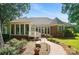 Exterior view of the home's rear featuring a brick exterior and beautifully landscaped backyard at 15546 Thompson Rd, Mint Hill, NC 28227
