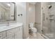 Bathroom featuring a single vanity, toilet, and glass enclosed shower at 15546 Thompson Rd, Mint Hill, NC 28227