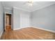 Bedroom featuring wood floors, neutral walls, and a white closet at 15546 Thompson Rd, Mint Hill, NC 28227