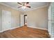 Bedroom boasts hardwood floors, neutral walls, a ceiling fan, and access to a bathroom at 15546 Thompson Rd, Mint Hill, NC 28227