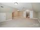 Spacious bonus room with neutral carpeting, a ceiling fan, and multiple storage closets at 15546 Thompson Rd, Mint Hill, NC 28227