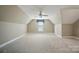 Expansive bonus room with vaulted ceilings, neutral carpeting, and a ceiling fan at 15546 Thompson Rd, Mint Hill, NC 28227