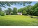 Well maintained home with lush green lawn and mature landscaping at 15546 Thompson Rd, Mint Hill, NC 28227