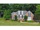Charming brick home with a landscaped yard and a covered entryway at 15546 Thompson Rd, Mint Hill, NC 28227