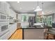 Open kitchen with granite countertops, stainless appliances, and adjacent dining area, ideal for entertaining at 15546 Thompson Rd, Mint Hill, NC 28227