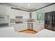 Modern kitchen boasts white cabinets, stainless steel appliances, and lots of natural light at 15546 Thompson Rd, Mint Hill, NC 28227