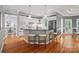 Spacious kitchen with large island, white cabinetry, and modern appliances, open to dining area at 15546 Thompson Rd, Mint Hill, NC 28227