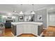Well-designed kitchen featuring an island with ample storage and open to living area with fireplace at 15546 Thompson Rd, Mint Hill, NC 28227