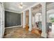 Open living area showcases architectural columns, tile flooring, and a glimpse of a stylish living room at 15546 Thompson Rd, Mint Hill, NC 28227