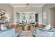 Living room with statement ceiling fan, hardwood floors, and neutral grey walls at 15546 Thompson Rd, Mint Hill, NC 28227