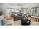 Bright living room with hardwood floors, gray sofa, and an open concept view of the kitchen at 15546 Thompson Rd, Mint Hill, NC 28227