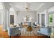 Elegant living room featuring hardwood floors, classic columns, and stylish modern decor at 15546 Thompson Rd, Mint Hill, NC 28227
