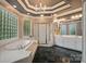 Main bathroom featuring a garden tub, glass block window, walk-in shower, and double vanities at 15546 Thompson Rd, Mint Hill, NC 28227
