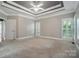 Large main bedroom with trey ceiling, plantation shutters, and neutral carpeting at 15546 Thompson Rd, Mint Hill, NC 28227