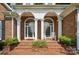 Covered brick porch with rocking chairs at 15546 Thompson Rd, Mint Hill, NC 28227