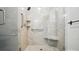 Bright shower featuring light tile, grab bars, a corner seat, and glass doors at 15546 Thompson Rd, Mint Hill, NC 28227