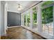 Bright sunroom with tile floors, offering serene views and an abundance of natural light through large windows at 15546 Thompson Rd, Mint Hill, NC 28227