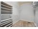 Walk-in closet with multiple shelves and rods for optimal organization and storage space at 15546 Thompson Rd, Mint Hill, NC 28227