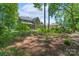 Expansive backyard showcasing the home's exterior and lush landscaping, backing to wooded area at 1959 Landry Ln, Rock Hill, SC 29732