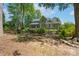 Lovely backyard with mature trees, landscaping, and a cozy fire pit area, ideal for outdoor gatherings at 1959 Landry Ln, Rock Hill, SC 29732