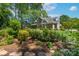 Beautifully landscaped backyard with colorful flowers, mature trees, and lush greenery for privacy at 1959 Landry Ln, Rock Hill, SC 29732