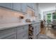 The gray kitchen offers modern cabinetry, quartz countertops, herringbone backsplash, and pull out spice rack at 1959 Landry Ln, Rock Hill, SC 29732