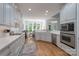 Bright kitchen featuring white cabinets, stainless steel appliances, light countertops and an eat-in dining space at 1959 Landry Ln, Rock Hill, SC 29732