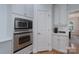 Bright kitchen with stainless steel appliances, white cabinets, tile backsplash and quartz countertops at 1959 Landry Ln, Rock Hill, SC 29732
