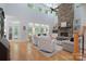 Open living room featuring hardwood floors, a stone fireplace and natural light at 1959 Landry Ln, Rock Hill, SC 29732