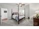 This bedroom has a four-poster bed frame, ceiling fan, and neutral finishes at 299 Barber Loop, Mooresville, NC 28117