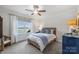 This bedroom has a water view, curtains with blue accents, and ceiling fan at 299 Barber Loop, Mooresville, NC 28117