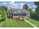 Gorgeous home with manicured lawn, stone fountain feature, screened porch and lake views at 299 Barber Loop, Mooresville, NC 28117