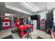 Organized garage space with a red work table, a TV, tool cabinets, and American and Canadian flags at 299 Barber Loop, Mooresville, NC 28117