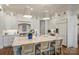 Bright kitchen featuring white cabinetry, stone countertops, and woven bar stool seating at 299 Barber Loop, Mooresville, NC 28117