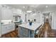 Gourmet kitchen with stainless steel appliances, center island with seating, and hardwood floors at 299 Barber Loop, Mooresville, NC 28117